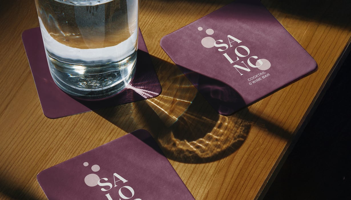 Glass of water on SALONG coaster.
