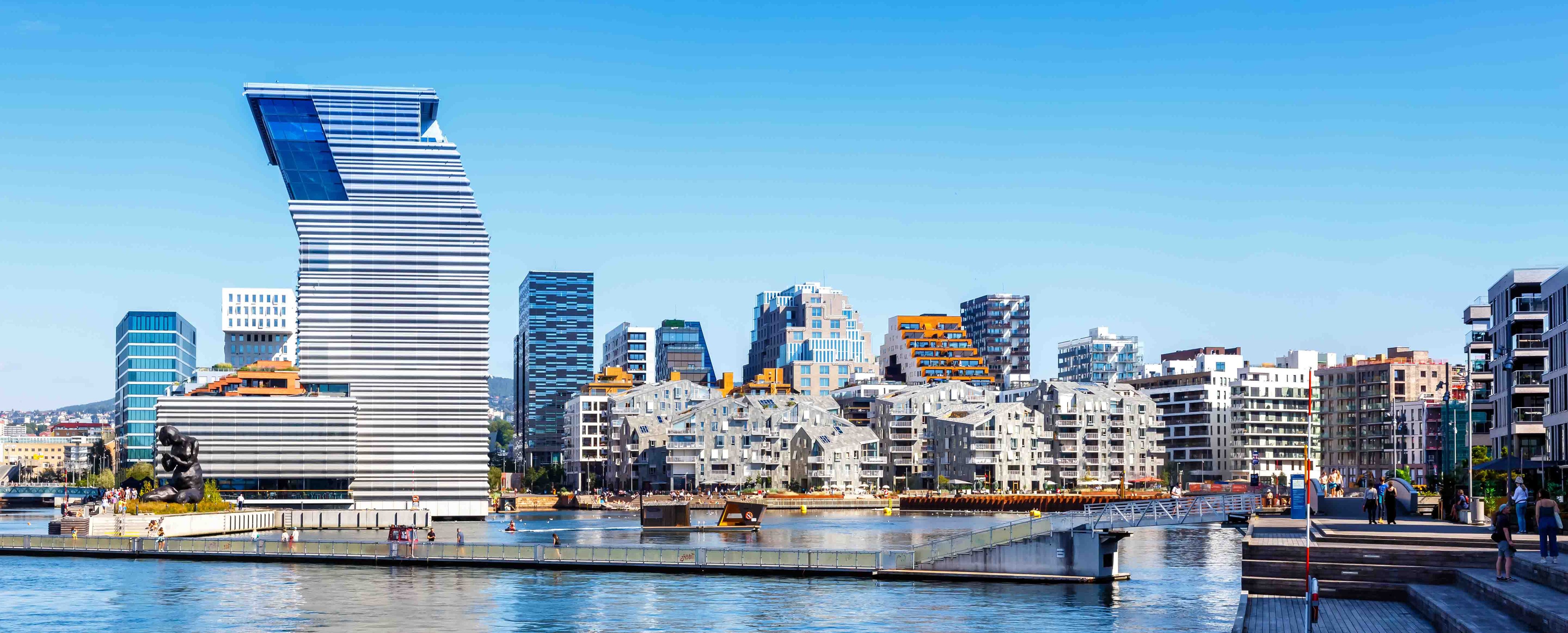 ALT text: Modern waterfront cityscape with a uniquely designed high-rise building