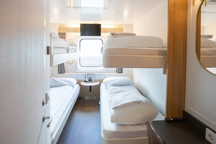 Pet-friendly cabin with two sets of bunk beds and a window.