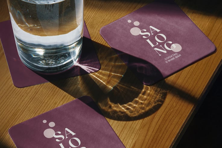Glass of water on SALONG coaster.