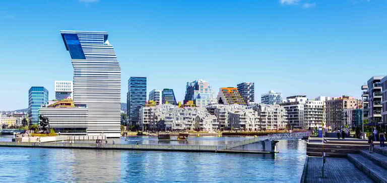 ALT text: Modern waterfront cityscape with a uniquely designed high-rise building